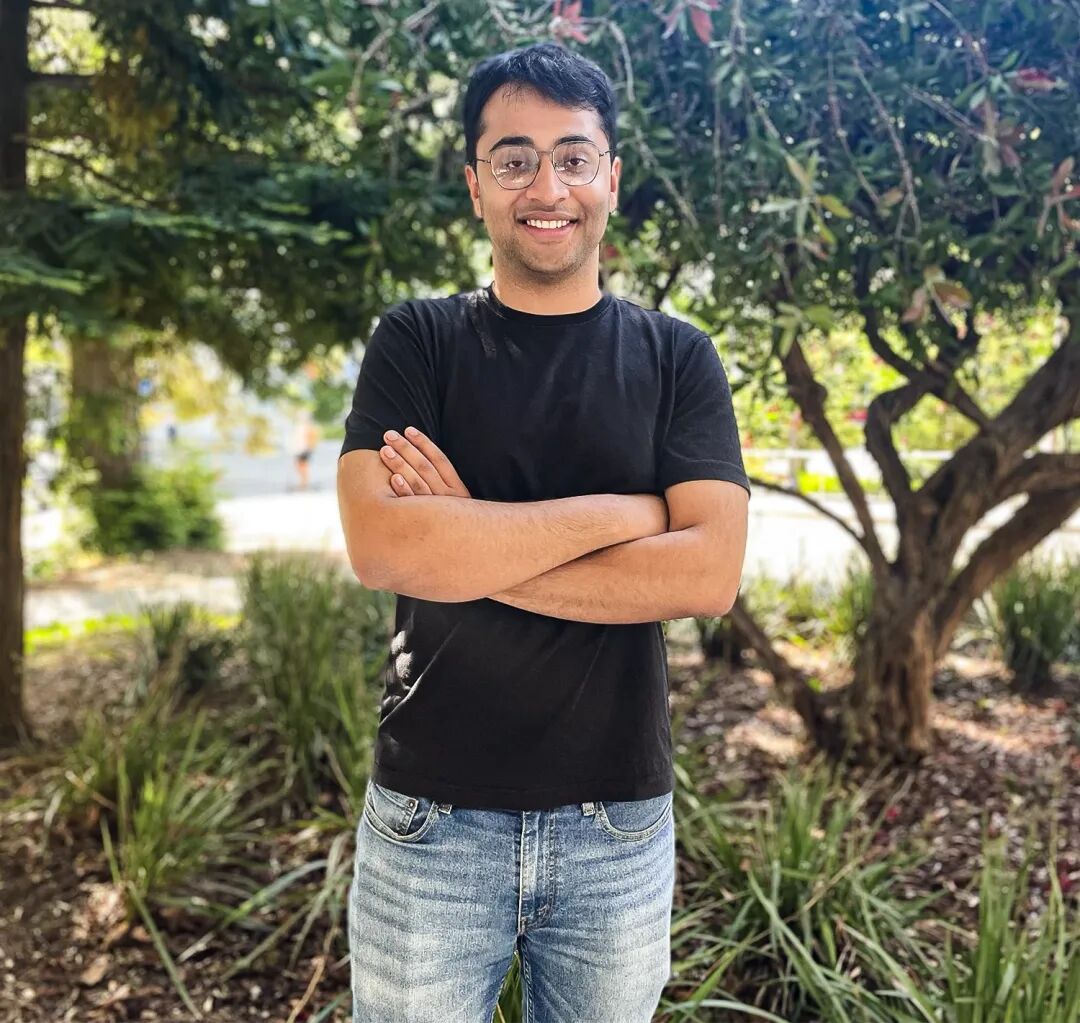 Kabir Tomer standing outdoors in a black shirt and jeans.